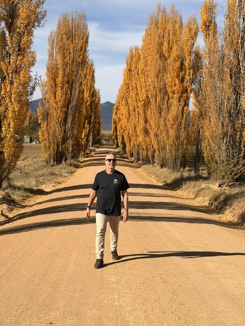 Stephen Moore walking along a tree-lined country road